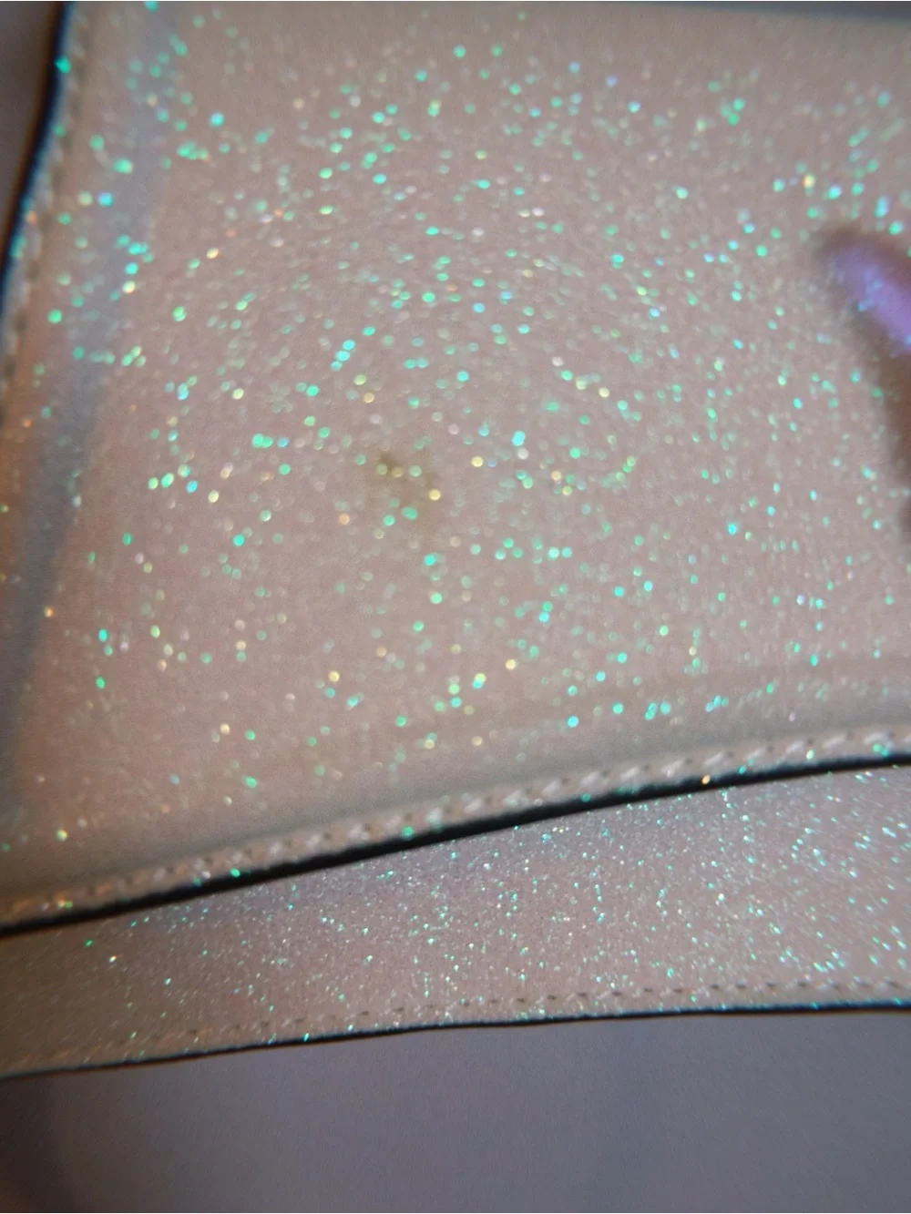 ALDO Akeelax mini bag featuring a sparkling finish and a vibrant iridescent butt